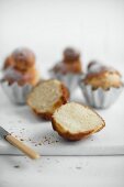 A halved brioche on a white chopping board