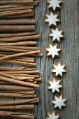 Cinnamon sticks and cinnamon stars on a wooden surface