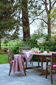 Dining area on terrace with horse paddock in background