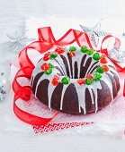 Chocolate fruit cake with white sugar icing and candied fruit