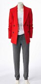 A red blazer, a white shirt and grey trousers on a headless mannequin