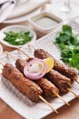 Seekh kebab with onion and lemon (meat skewers, India)