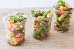 Three glasses of asparagus salad with crayfish