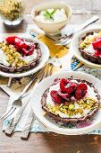Chocolate tartlets with ricotta, cherries and pistachio nuts