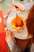 A child eating tomato soup with a puff pastry topping