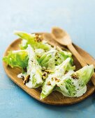 Iceberg lettuce wedges with a blue cheese dressing and roasted walnuts