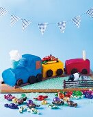 A colourful train cake filled with sweets for a children's birthday party