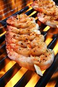 Spicy prawn skewers on a flaming grill