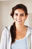 Young, brunette woman wearing hooded sweater