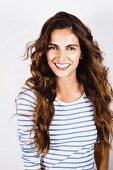 Young, brunette woman wearing white and blue striped top