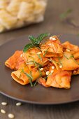 Paccheri with a tomato and ricotta sauce and pine nuts