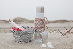 Thermos flask with pink crocheted cover for beach picnic