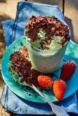 Pistachio ice cream with grated chocolate and strawberries