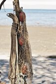 Flotsam on sandy beach: ropes and fishing nets