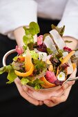 Mixed leaf salad with carrots and radishes