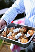 Chicken legs in a roasting tin for a picnic