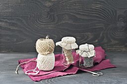 Old jam jars used as string dispensers