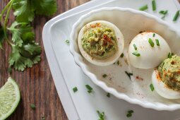Two devilled eggs with avocado cream