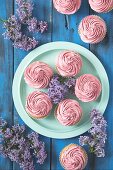 Cupcakes with raspberry frosting on a plate