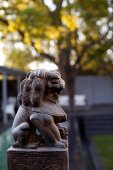 Stylised animal sculpture on plinth in garden