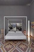 Bedroom with modern four-poster bed on antique terrazzo floor