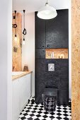 Custom chipboard bathroom with chequered floor and black toilet