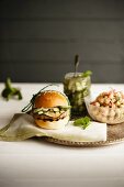 A vegetarian bean burger with cucumber relish and a chickpea salad