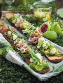Baguettes topped with Parma ham and marinated beans