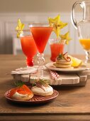 Blinis with smoked fish and Campari cocktails