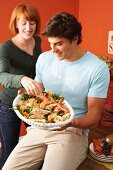 A young couple with a seafood platter