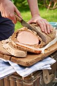 Smoked pork in a bread dough for a picnic