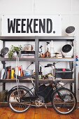 Vintage bicycle in front of metal shelving and large sign