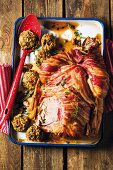 Roast chicken with an apple and walnut stuffing wrapped in bacon
