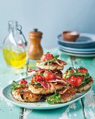 Potato fritters with bacon, tomatoes and rocket