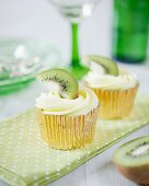 Fruity cupcakes with kiwi frosting and slices of kiwi