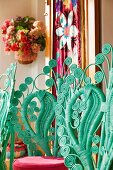 Backrests of turquoise peacock chairs with many curlicues