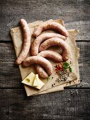 Cheese filled sausages on a piece of paper with spices and cheese