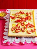 Sour cream cheesecake with strawberries and passion fruit on a baking tray