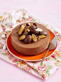 Chocolate mousse cake decorated with Easter eggs and honeycomb