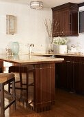 Glossy, brown, country-house kitchen with counter in elegant interior