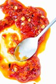 Calabrian chilli salsa with a spoon