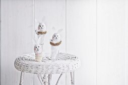 Blown eggs made into Easter bunnies in white surroundings