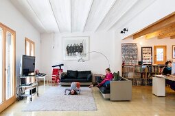 Familienleben in offenem Wohnbereich mit gemütlichen Ledersofas im Designerstil
