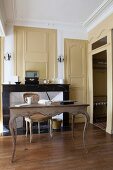 Antique desk in front of open fireplace with marble surround