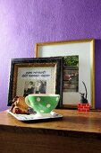 Retro cup on tray in front of framed photos