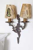 Vintage sconce lamp with newspaper lampshades and butterfly decoration