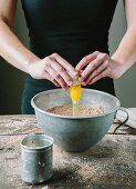 An egg yolk being added to a cake mixture