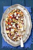 Couscous salad with grilled vegetables (courgette, aubergine, pepper, onion), feta cheese and pomegranate seeds