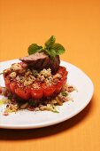 Tomato stuffed with couscous and lamb fillet