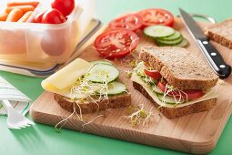 A cheese, cucumber, tomato and bean sprout sandwich for lunch box